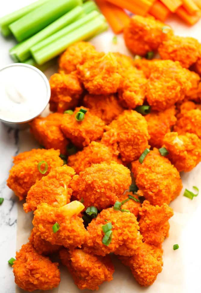 a bunch of cauliflower with hot sauce on a white background