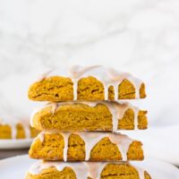 stack of vegan pumpkin scones with white background