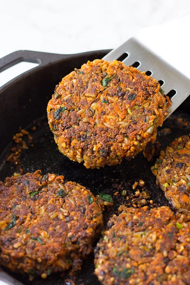 veggie burger being lifted out of a pan