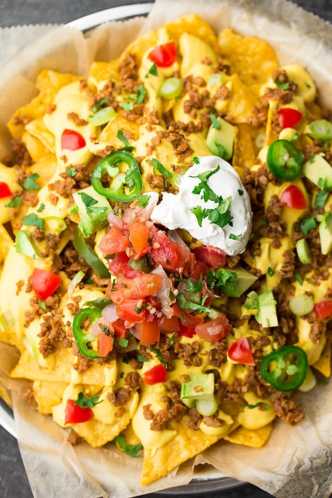 looking down on a plate of nachos with loads of toppings