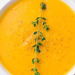 close up of a bowl of instant pot butternut squash soup with thyme