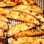 square photo of many potato fries on a pan