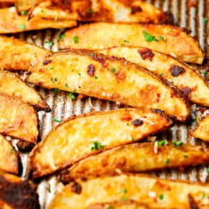 square photo of many potato fries on a pan