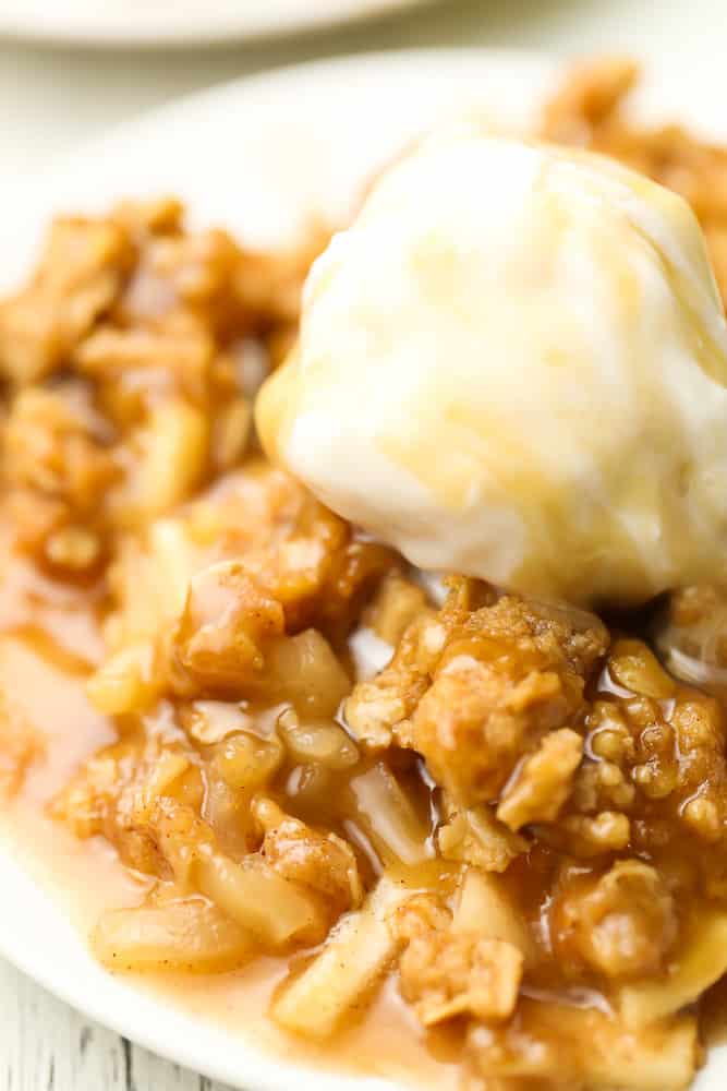 very close up of apple crisp on a plate with ice cream