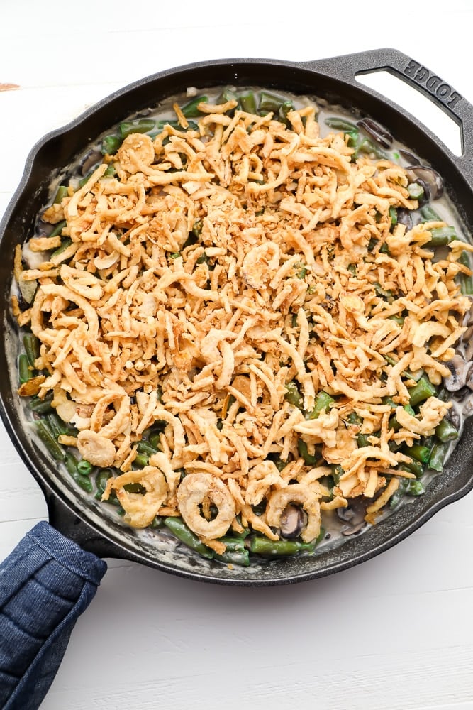 uncooked green bean dish in cast iron pan