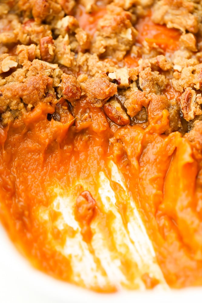 close up of scooped out sweet potatoes from casserole dish