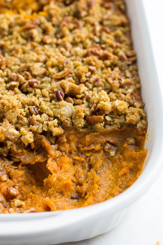 vegan sweet potato casserole with some taken out of the dish