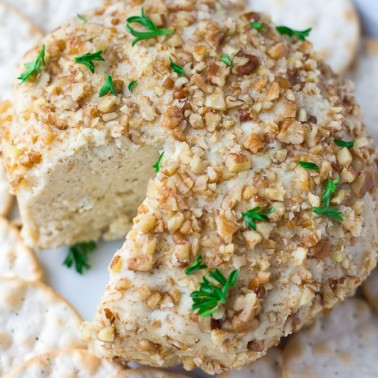 vegan cheeseball with crackers around it