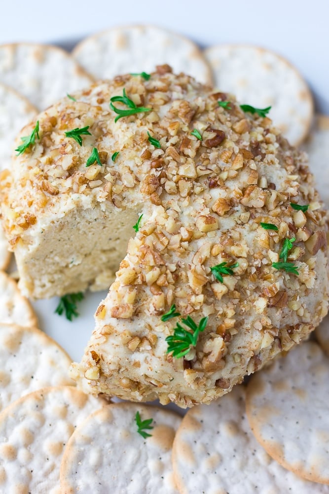 vegan cheeseball with crackers around it