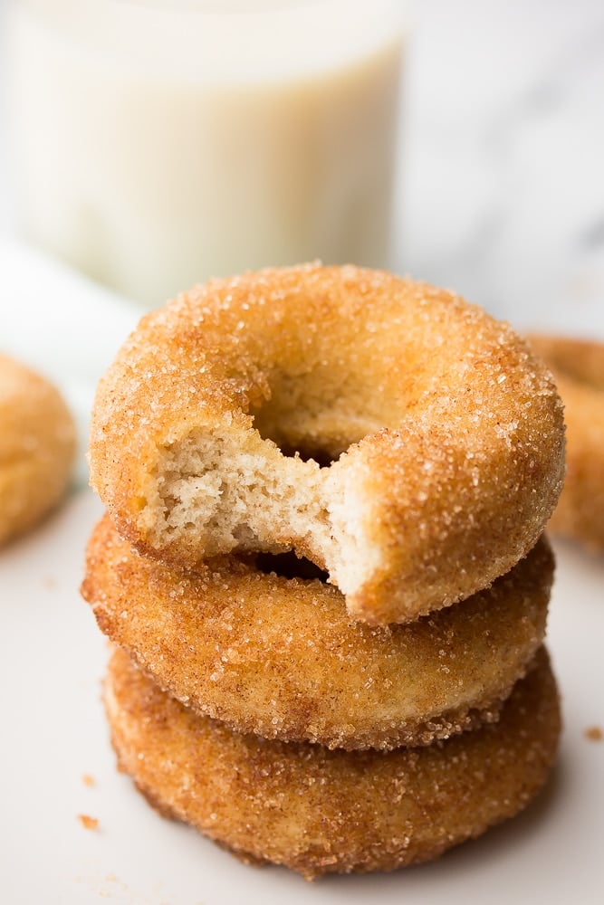 stack of donuts with a bite taken out of the top of one