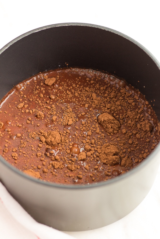 cocoa powder and other ingredients in a pot for vegan hot chocolate