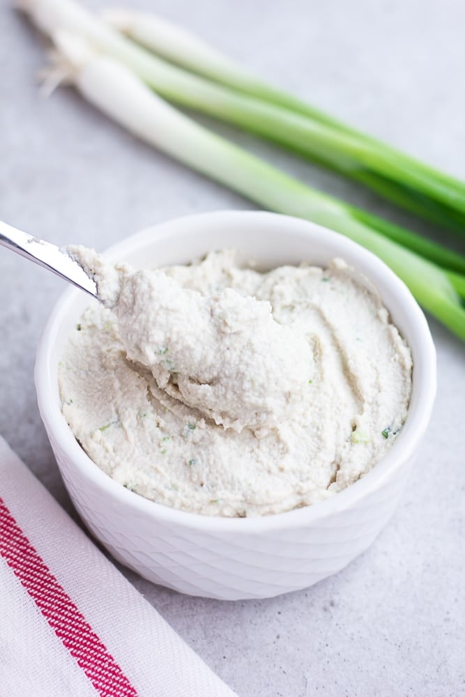 vegan cream cheese in a bowl with a knife