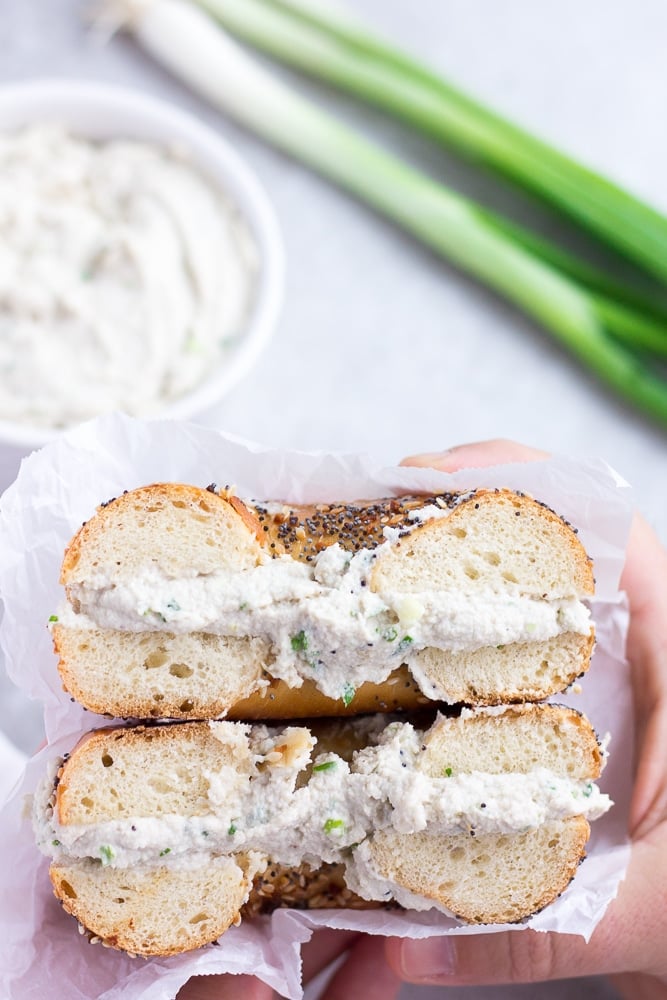 bagel cut in half with vegan cream cheese in it