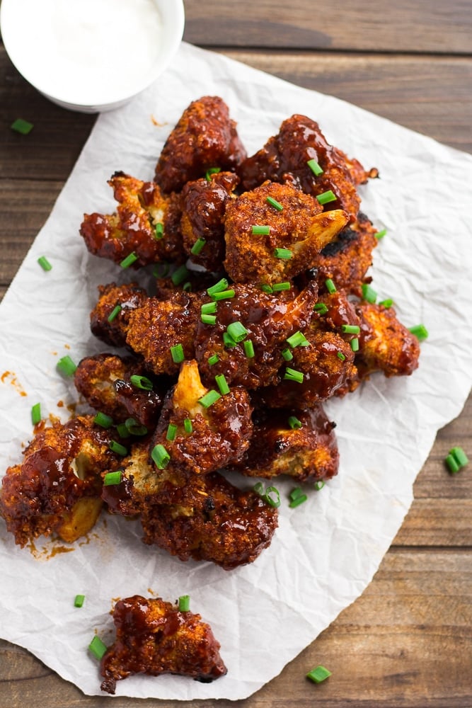 a lot of bbq cauliflower wings on parchment paper