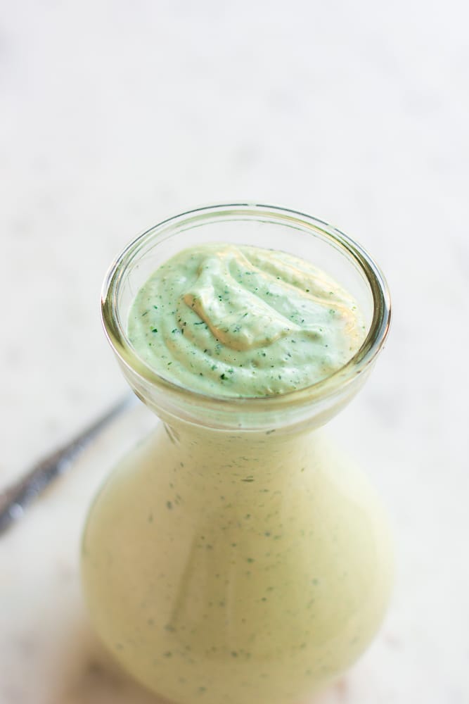 vegan green goddess dressing in a small glass dish.