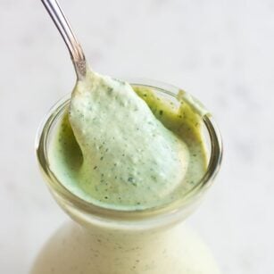vegan green goddess dressing in a dish with a spoon.