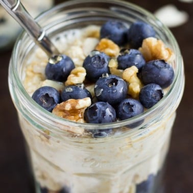 jar of vegan overnight oats with blueberries and walnuts