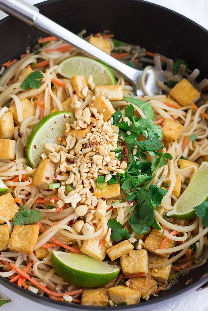 Vegan Pad Thai in a pan, with crushed peanuts on top