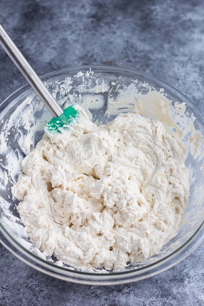 vegan cream cheese frosting in a bowl being mixed.