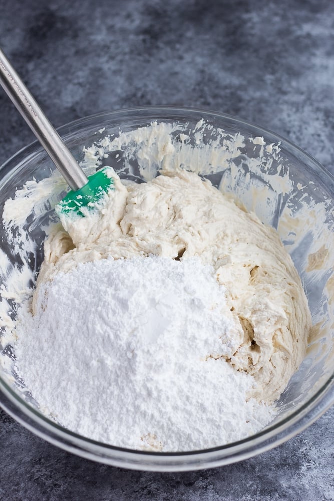 powdered sugar added to bowl to make vegan cream cheese frosting.