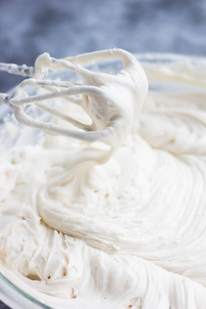 showing vegan cream cheese frosting with mixer in bowl.