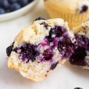 square image of a cut in half blueberry muffin showing inside texture