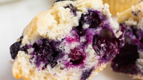 square image of a cut in half blueberry muffin showing inside texture
