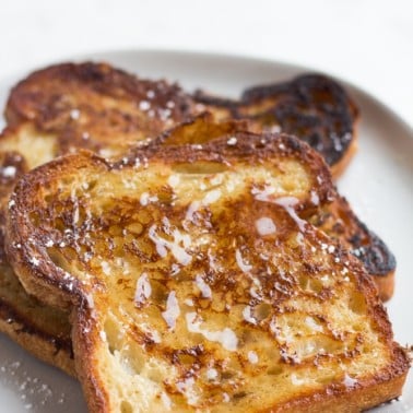 vegan french toast on a plate with syrup on it.