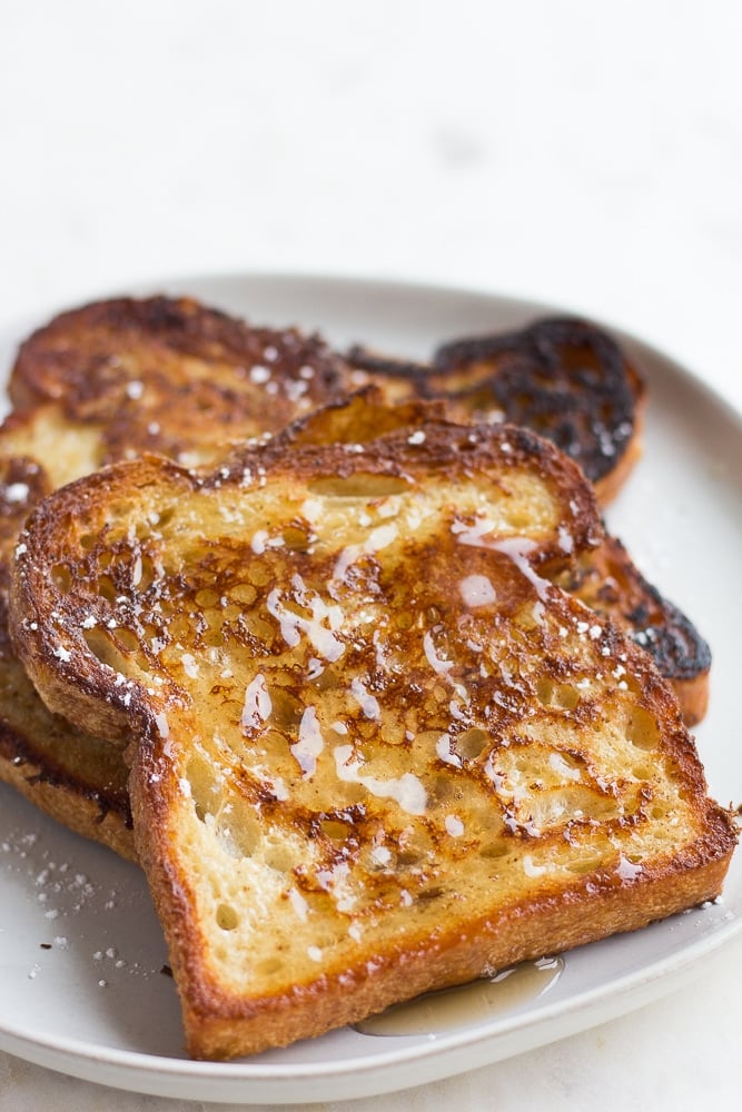 vegan french toast on a plate with syrup on it.