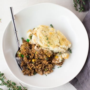 vegan shepherd's pie in a bowl looking down with a fork.