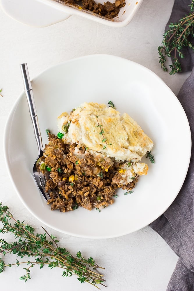 vegan shepherd's pie in a bowl looking down with a fork.