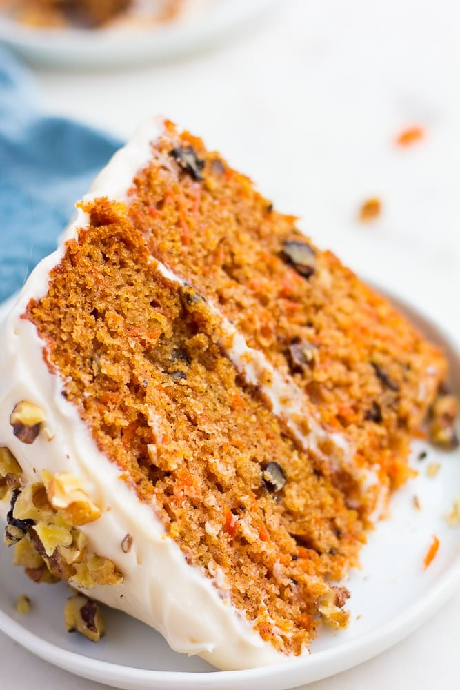 close up piece of vegan carrot cake on a white plate