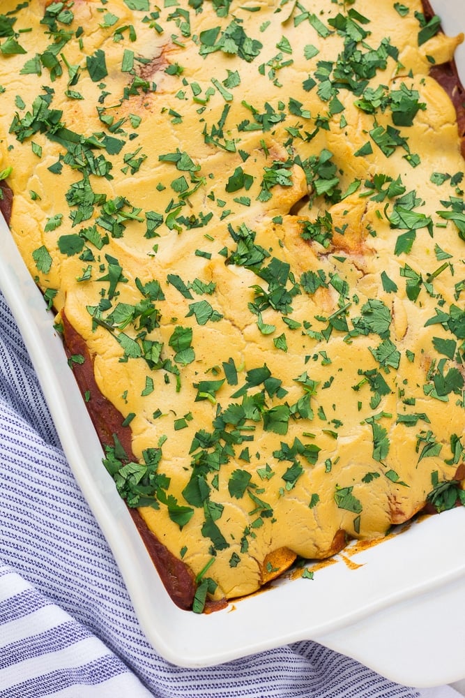 looking down on a dish of vegan enchiladas with cilantro