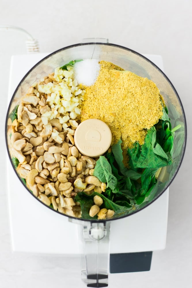 ingredients for vegan pesto in food processor before being blended.