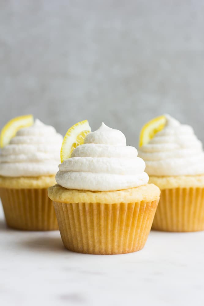 straight on photo of 3 vegan lemon cupcakes