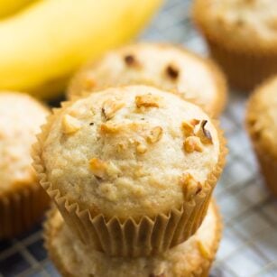 several muffins with banana in background.