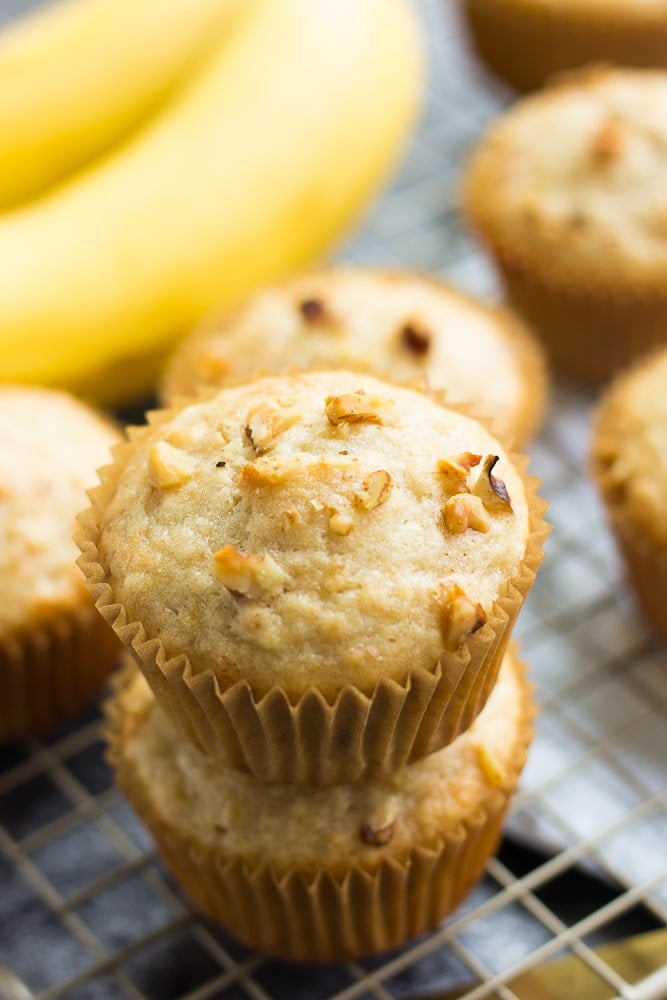 several muffins with banana in background.