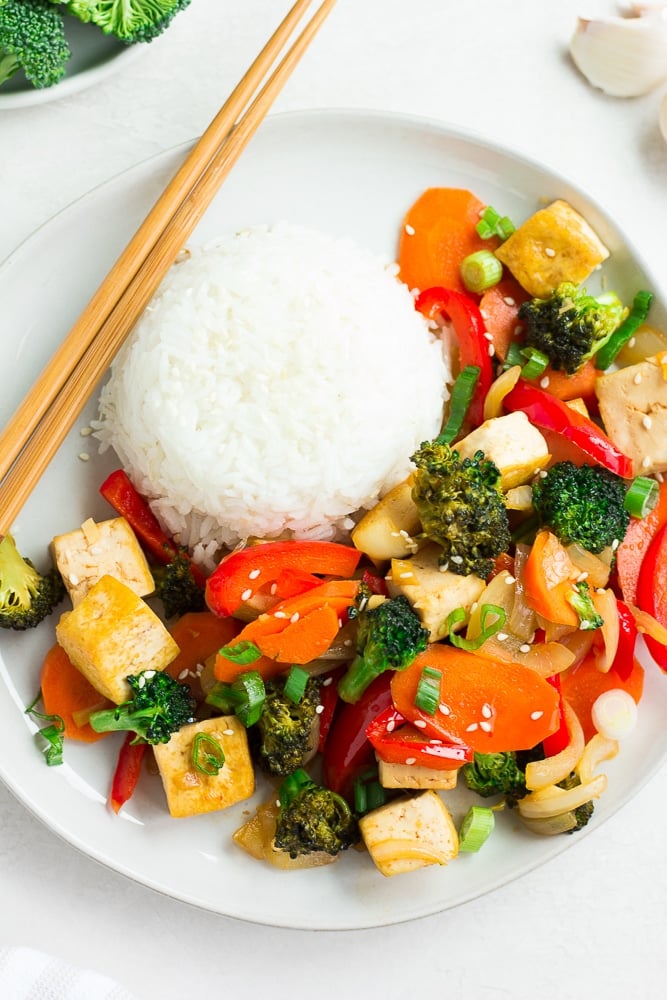 looking down on a plate of tofu stir fry with rice.