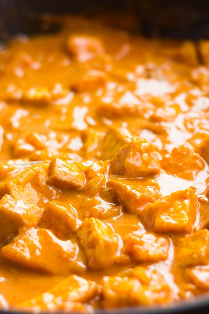 vegan butter chicken in a pan, cooked with sauce.