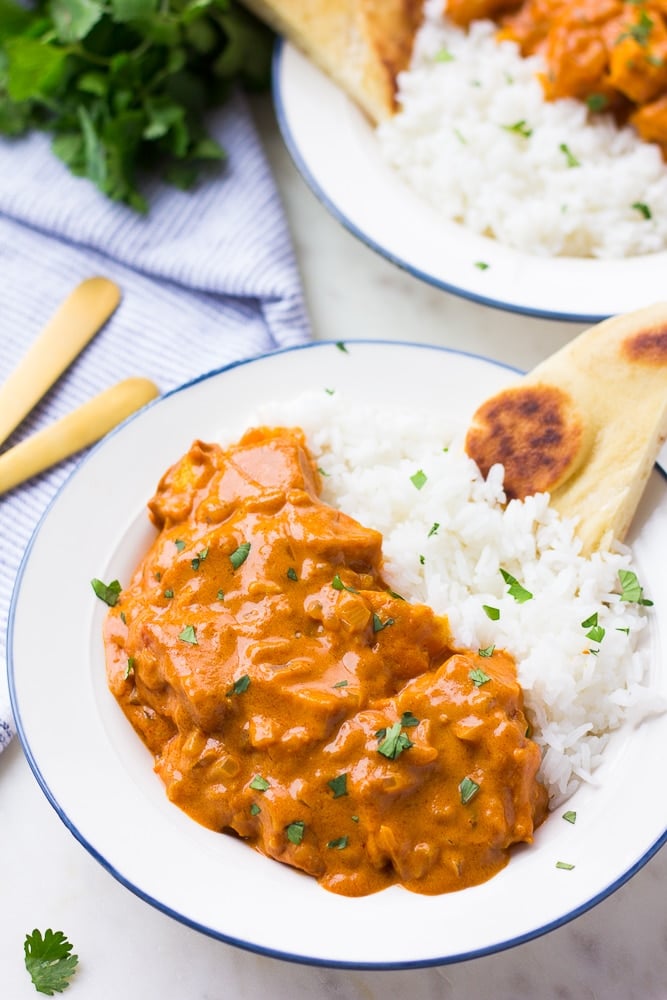 vegan butter chicken in a bowl with rice and naan