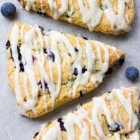 looking down on a few vegan blueberry scones with grey background