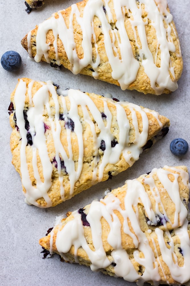 looking down on a few vegan blueberry scones with grey background