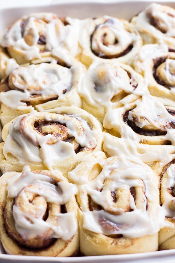 pan full of cinnamon rolls with frosting