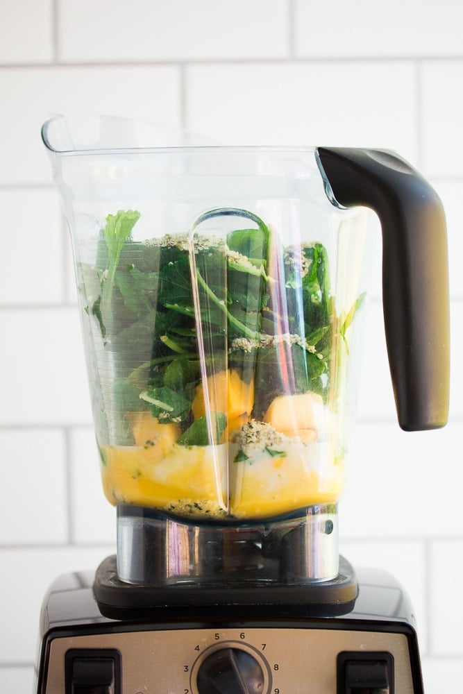 blender full of ingredients for vegan green smoothie, unblended.