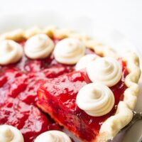 slice of strawberry pie being lifted out of pie plate.