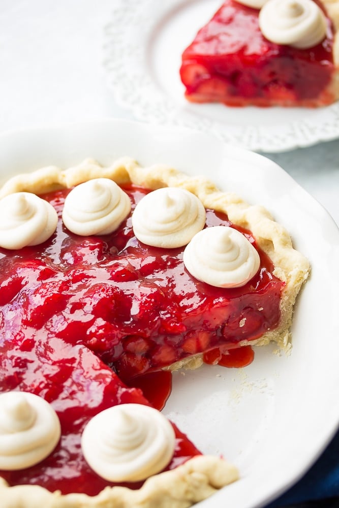 strawberry pie with slice taken out of it.