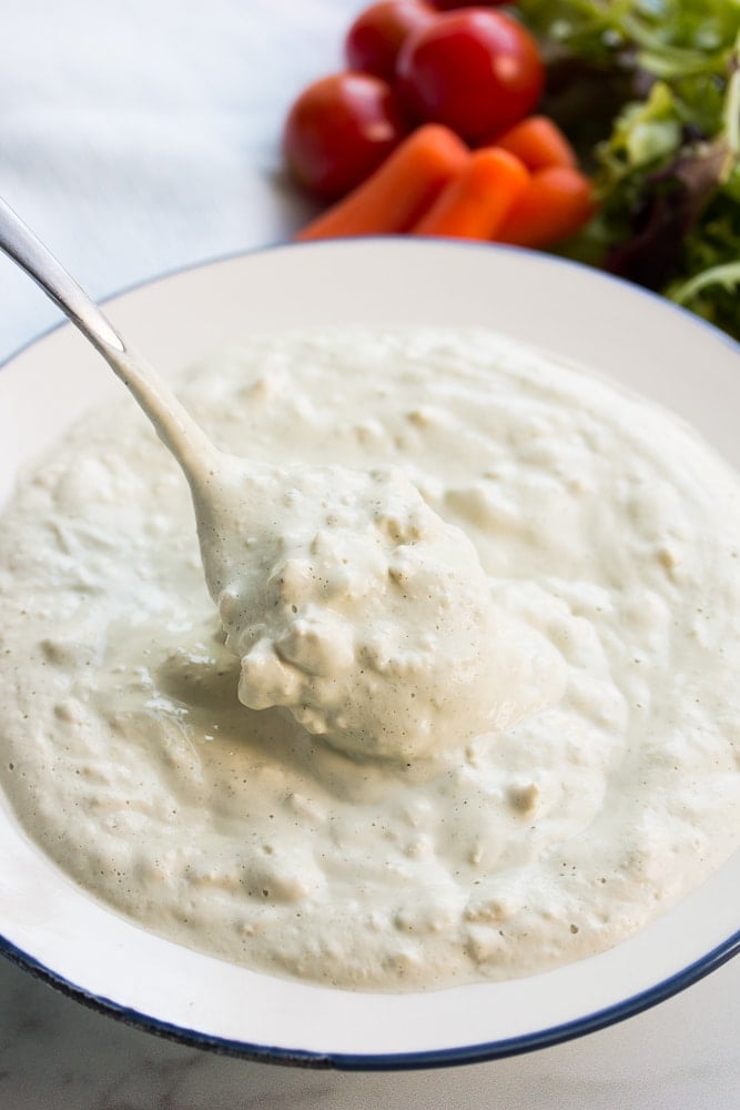 dressing with chunks and a spoonful from a bowl.