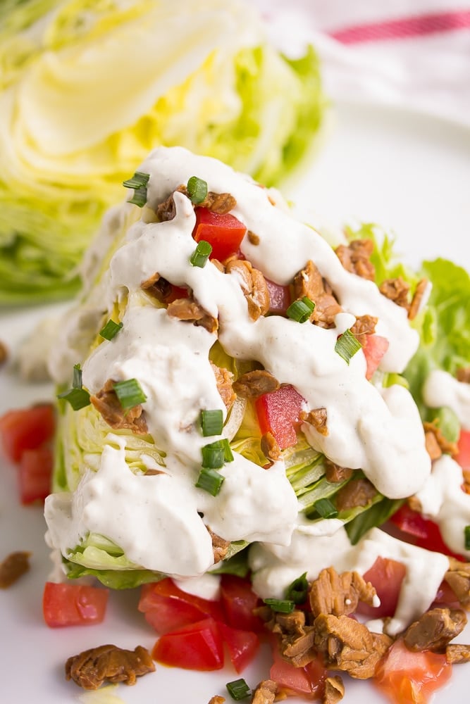 vegan wedge salad with blue cheese dressing drizzled on top.