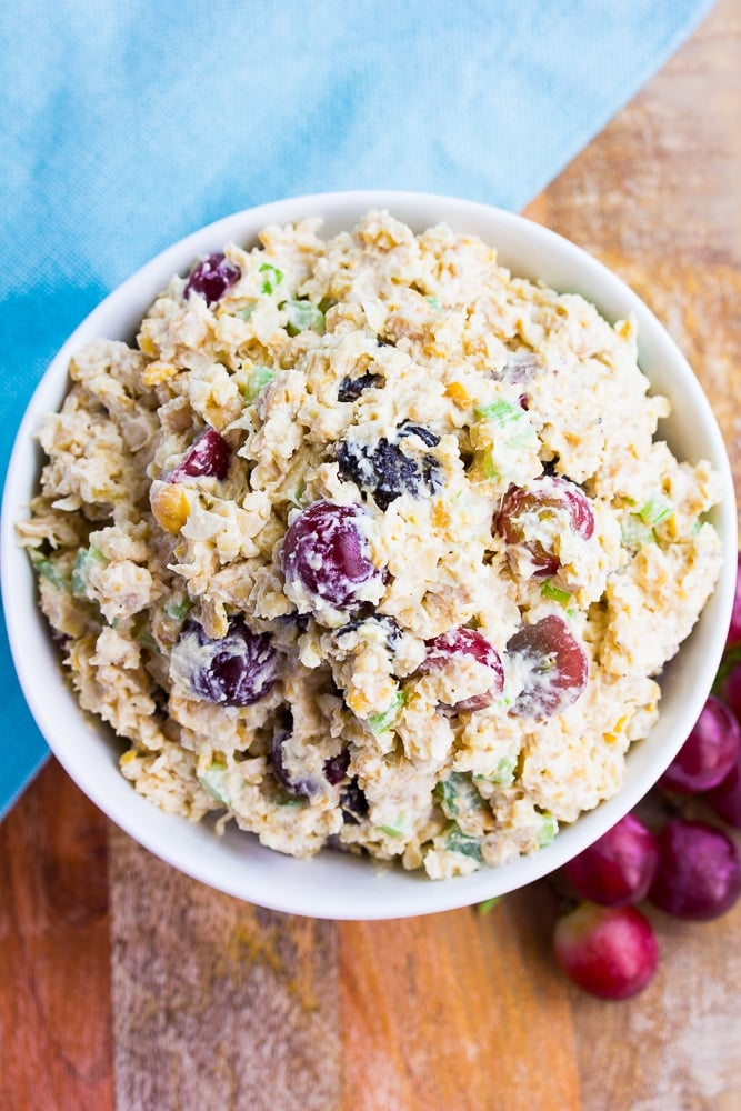 bowl full of vegan chicken salad with grapes and cherries.