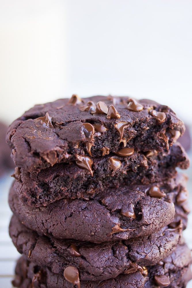 chocolate cookie broken in half on top of whole cookies